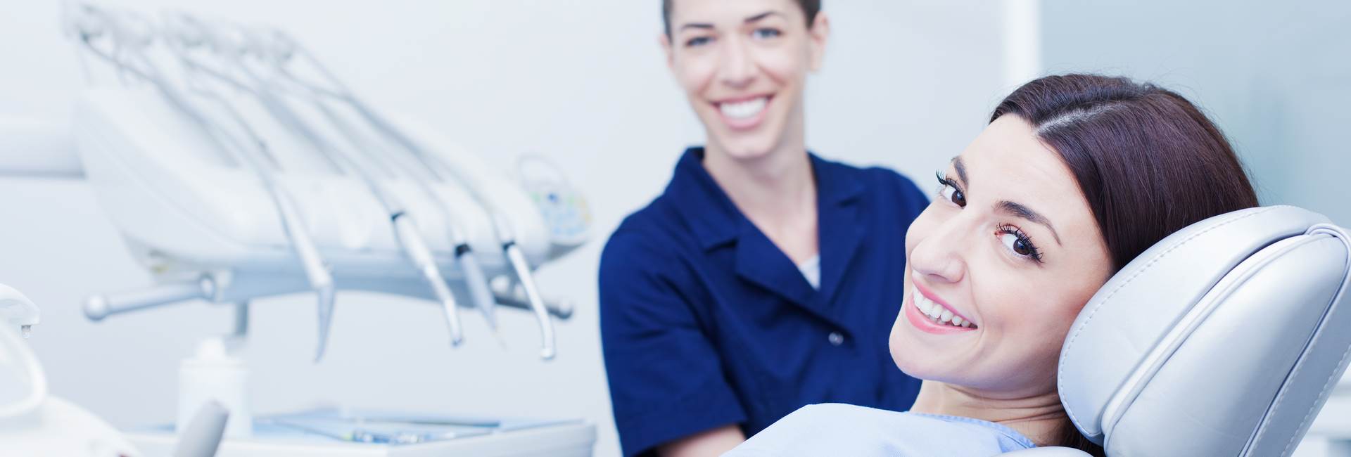 Beautiful woman and dentist smiling