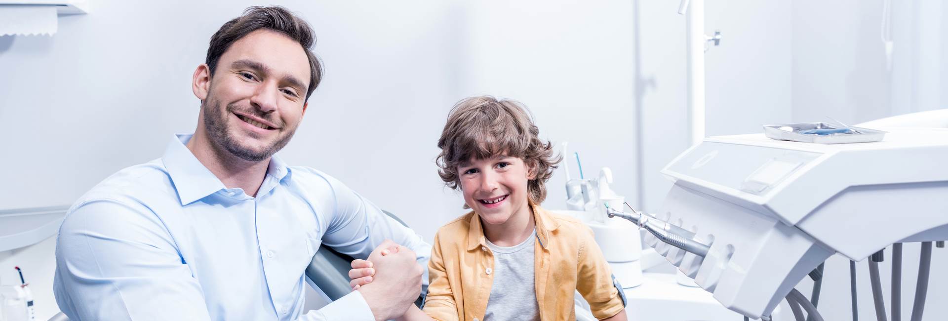 Kid and dentist smiling