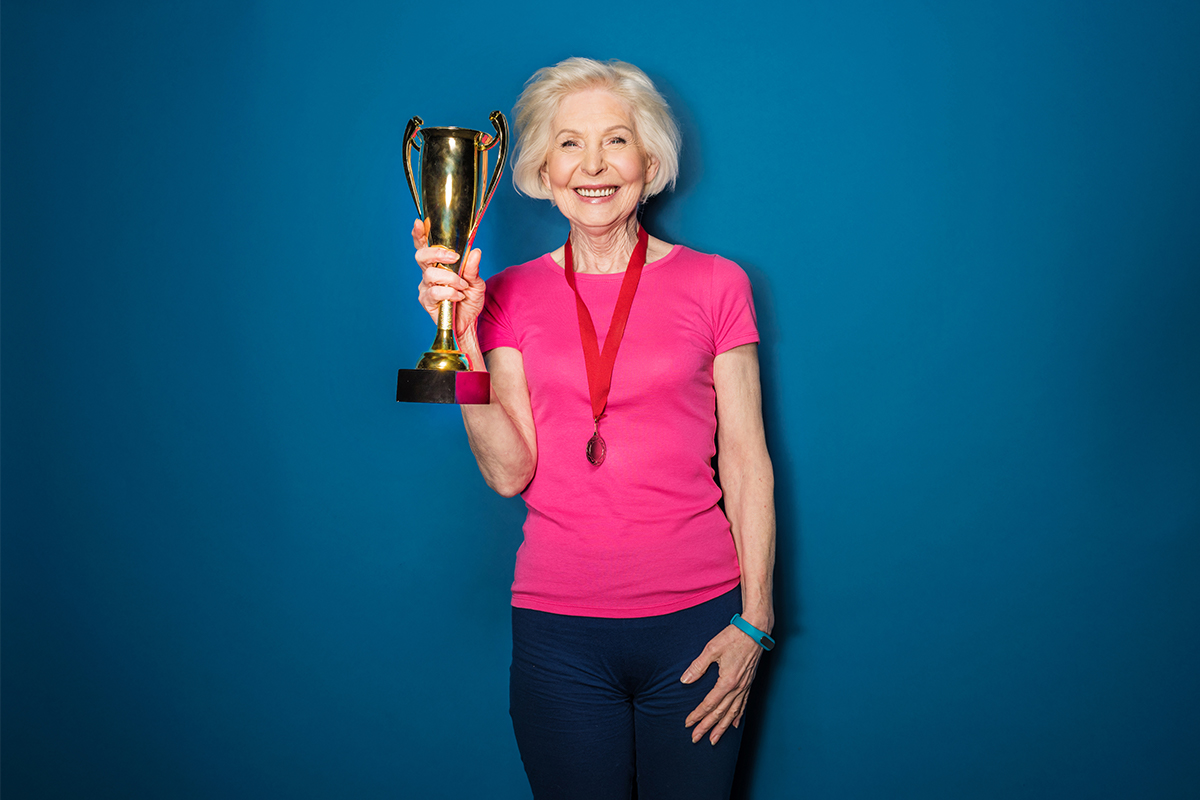 woman smiling with trophy